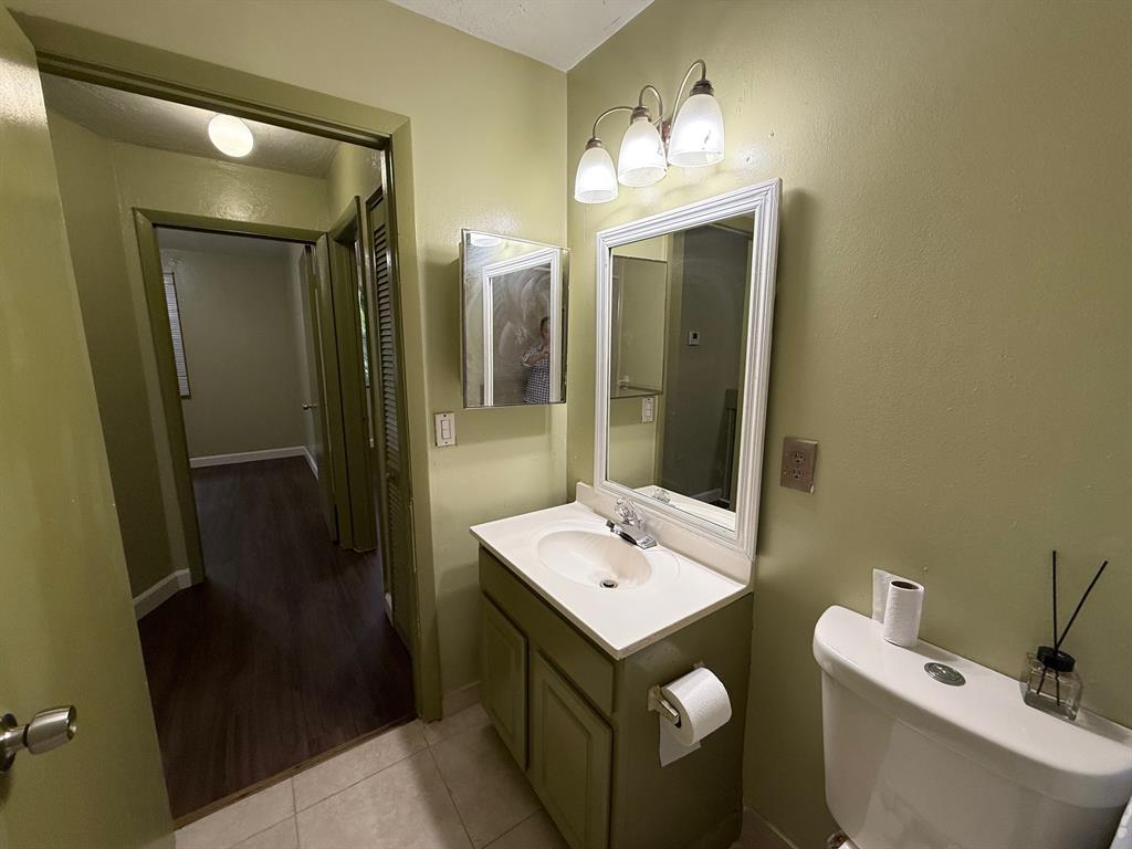 11571 Northwest 35th Street, Unit 11571 Coral Springs, FL 33065 - Photo 25 of 29 a bathroom with a sink and mirror with toilet