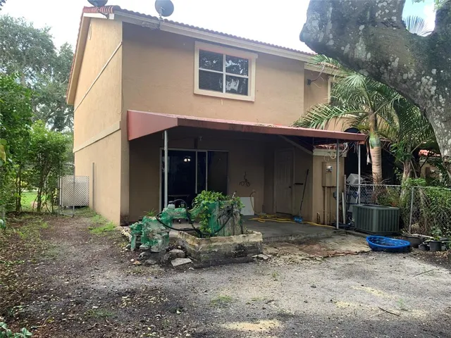 a view of a house with a backyard and porch