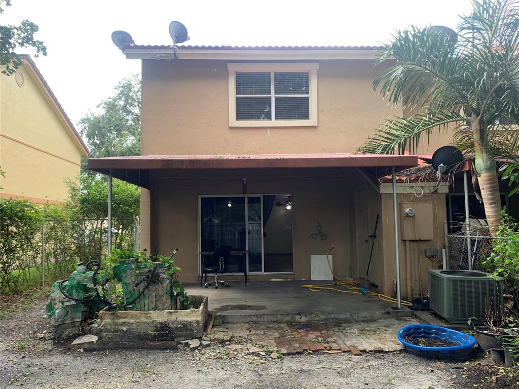 11571 Northwest 35th Street, Unit 11571 Coral Springs, FL 33065 - Photo 27 of 29 a view of a house with a backyard and porch