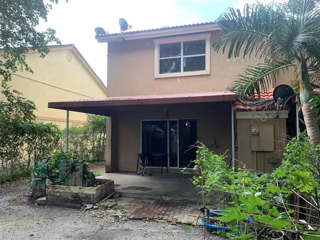 a backyard of a house with a fountain