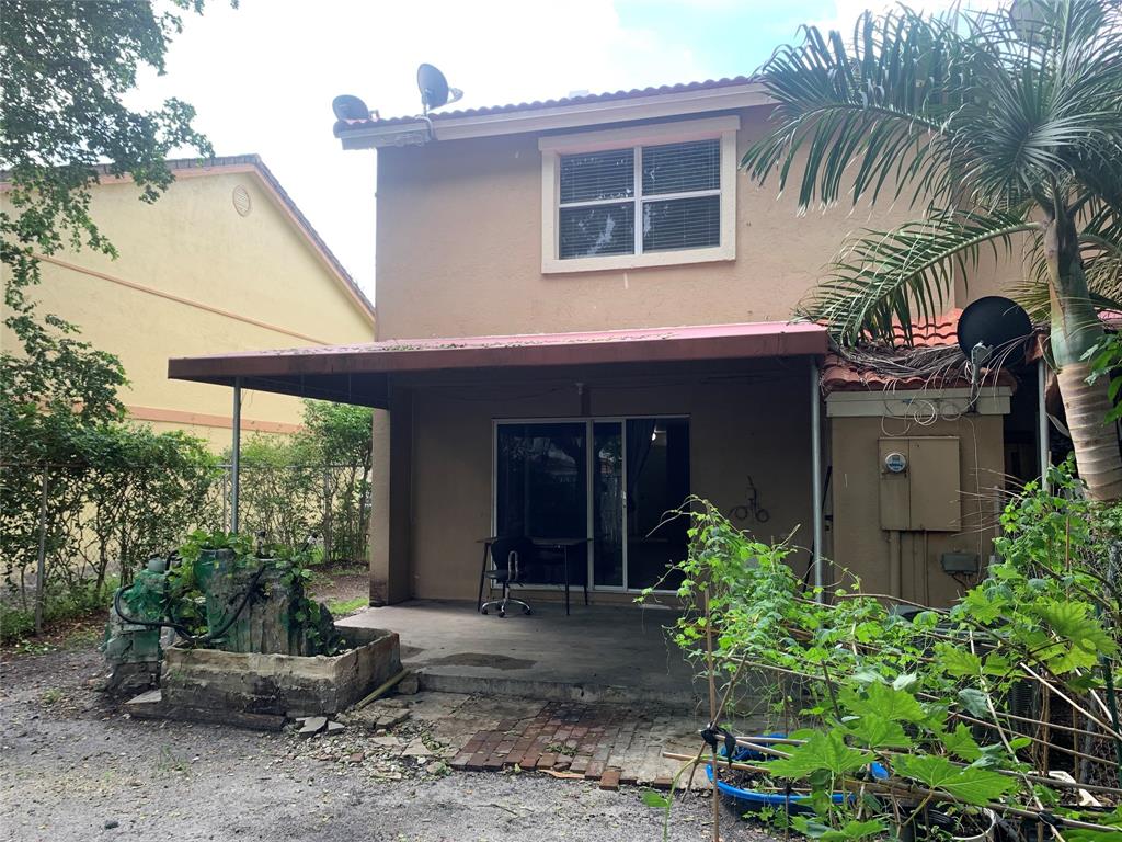 11571 Northwest 35th Street, Unit 11571 Coral Springs, FL 33065 - Photo 28 of 29 a front view of a house with a yard