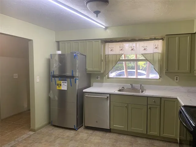 a kitchen with a stove and a sink