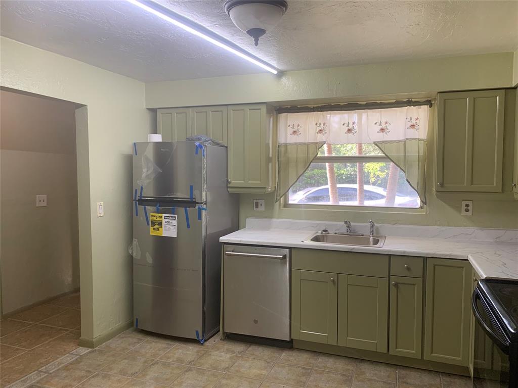 11571 Northwest 35th Street, Unit 11571 Coral Springs, FL 33065 - Photo 7 of 29 a kitchen with a refrigerator and a sink