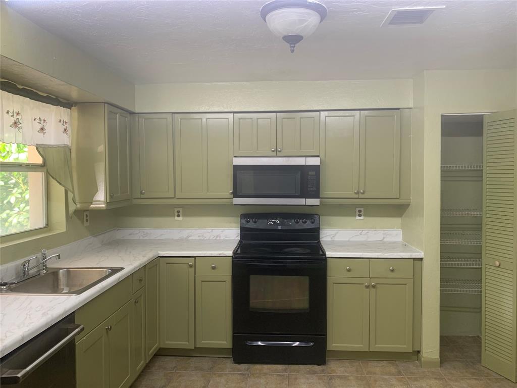 11571 Northwest 35th Street, Unit 11571 Coral Springs, FL 33065 - Photo 8 of 29 a kitchen with a stove and a sink