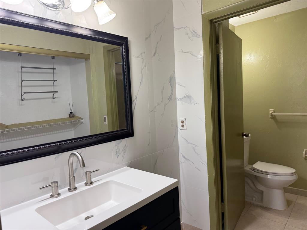 11571 Northwest 35th Street, Unit 11571 Coral Springs, FL 33065 - Photo 10 of 29 a bathroom with a sink a toilet and a mirror