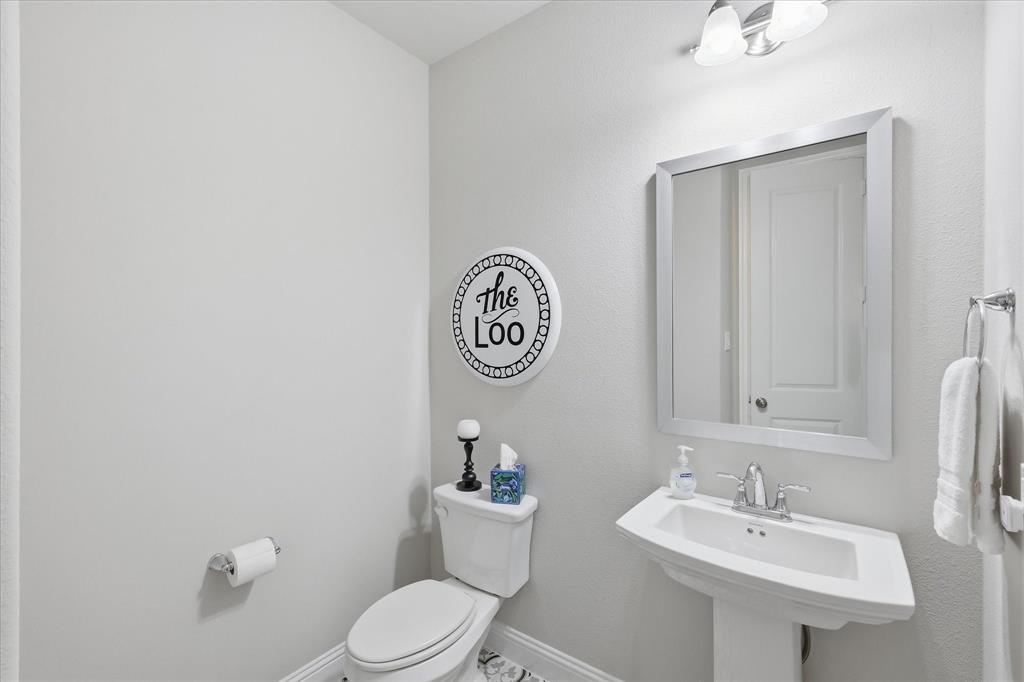 9708 Surveyor Road Oak Point, TX 75068 - Photo 30 of 34 Half Bath -Pedestal sink with chrome faucet, framed mirror, and wall-mounted vanity lighting