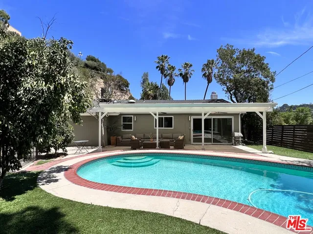 a front view of a house with a yard table and chairs