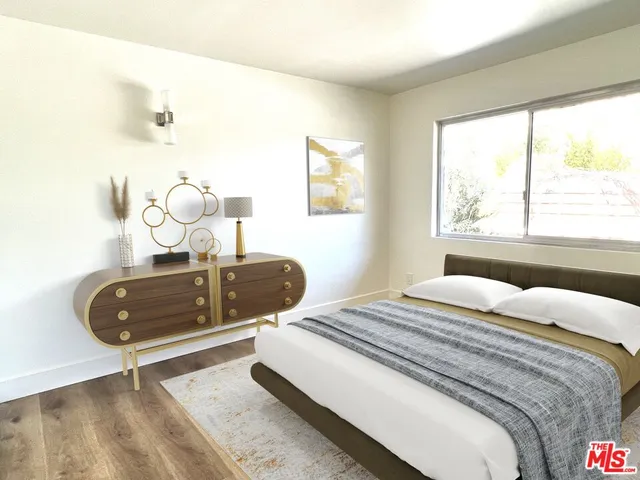 a bedroom with a bed and a large window