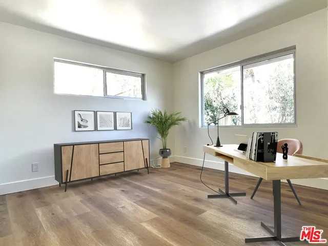 a workspace with furniture window and wooden floor