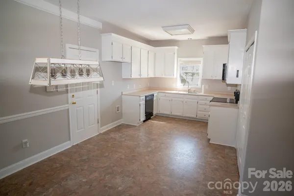 a kitchen with cabinets and window