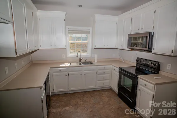 a kitchen with a sink stove and cabinets