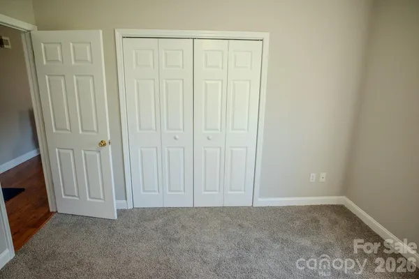 a view of an empty room with a fireplace