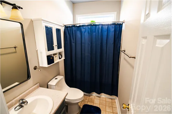 a white toilet sitting next to a bathroom sink