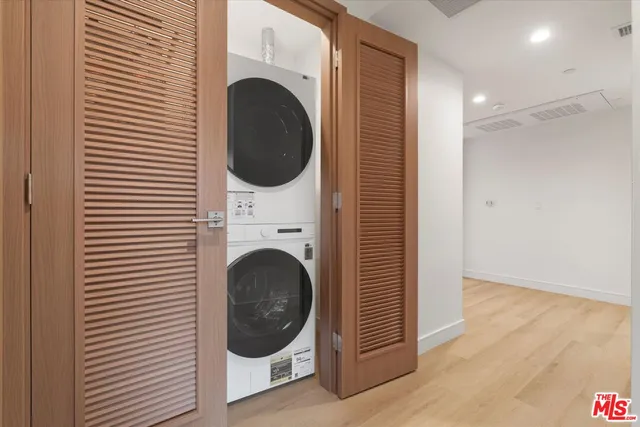 a view of a hallway with washer and dryer