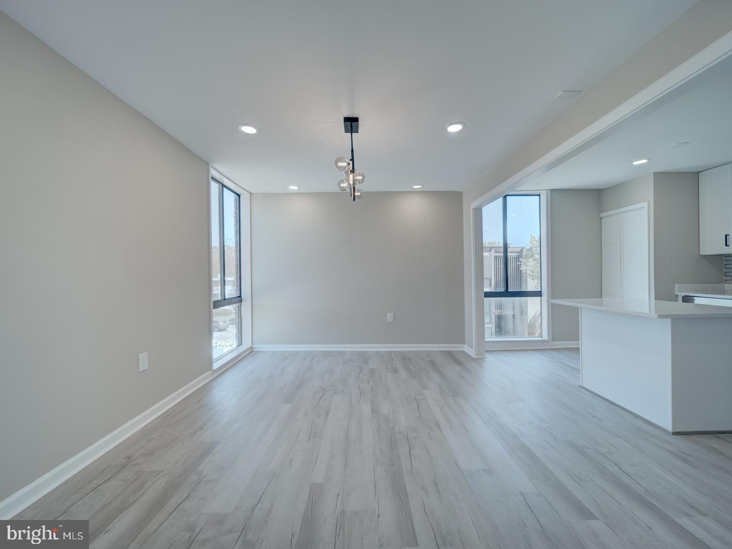 8675 Greenbelt Road, Unit 202 Greenbelt, MD 20770 - Photo 14 of 47 a view of an empty room with wooden floor and a window