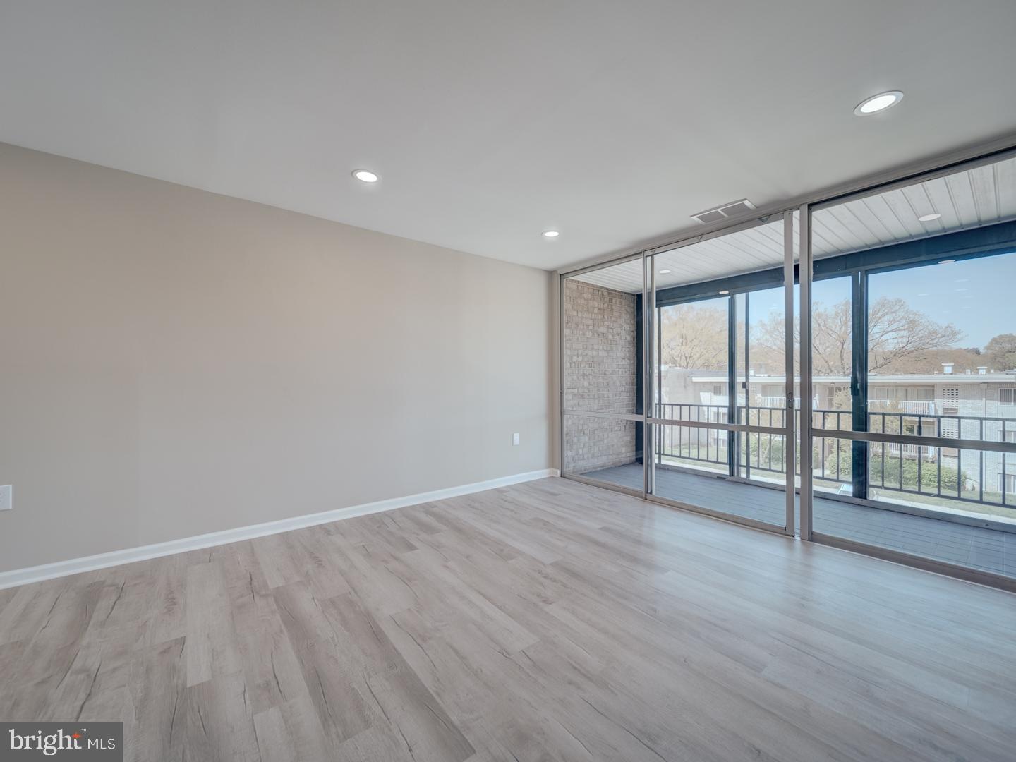 8675 Greenbelt Road, Unit 202 Greenbelt, MD 20770 - Photo 4 of 47 a view of an empty room with wooden floor and a window