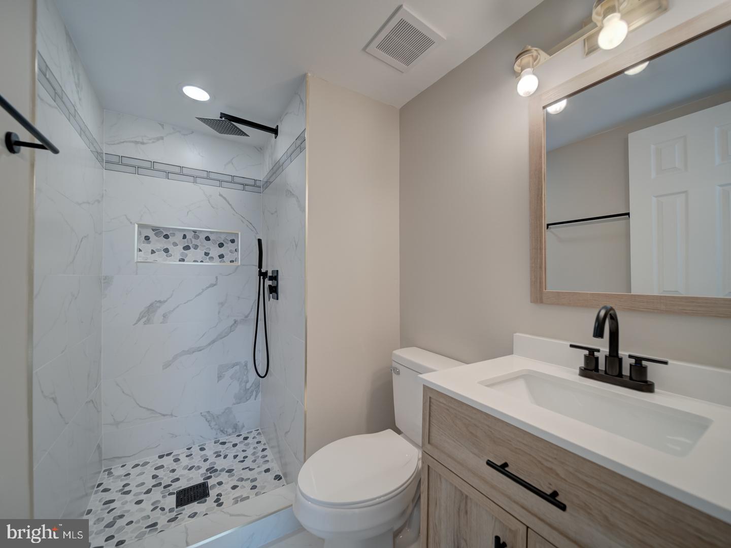 8675 Greenbelt Road, Unit 202 Greenbelt, MD 20770 - Photo 41 of 47 a bathroom with a sink a toilet and shower