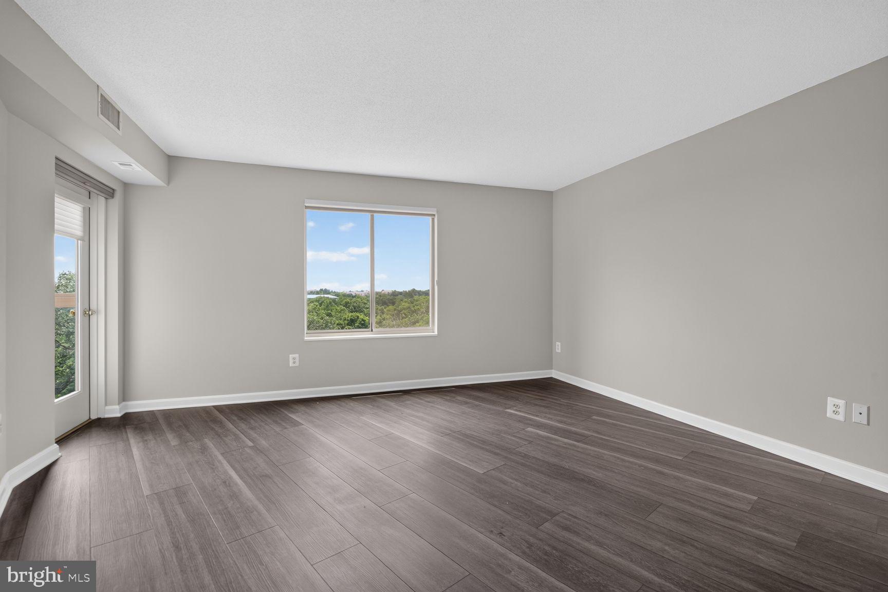19385 Cypress Ridge Terrace, Unit 903 Leesburg, VA 20176 - Photo 14 of 37 Primary bedroom with door onto the sunroom balcony
