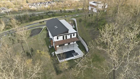 an aerial view of a house with a yard