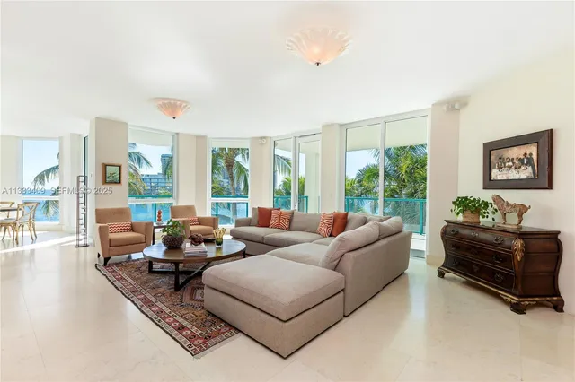 a living room with stainless steel appliances granite countertop furniture and a fireplace