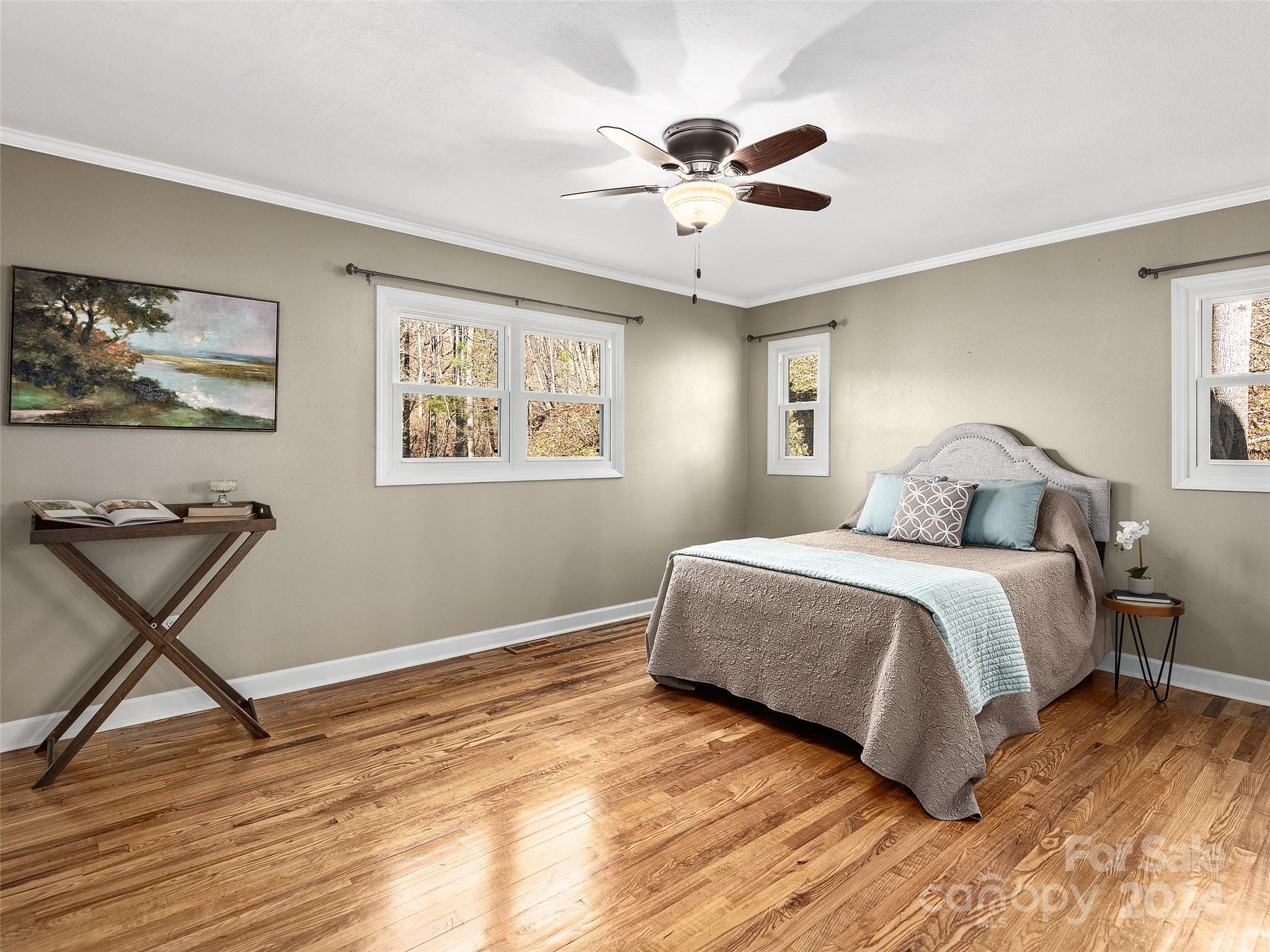 251 Jade Drive Clyde, NC 28721 - Photo 11 of 40 a bedroom with a bed and wooden floor