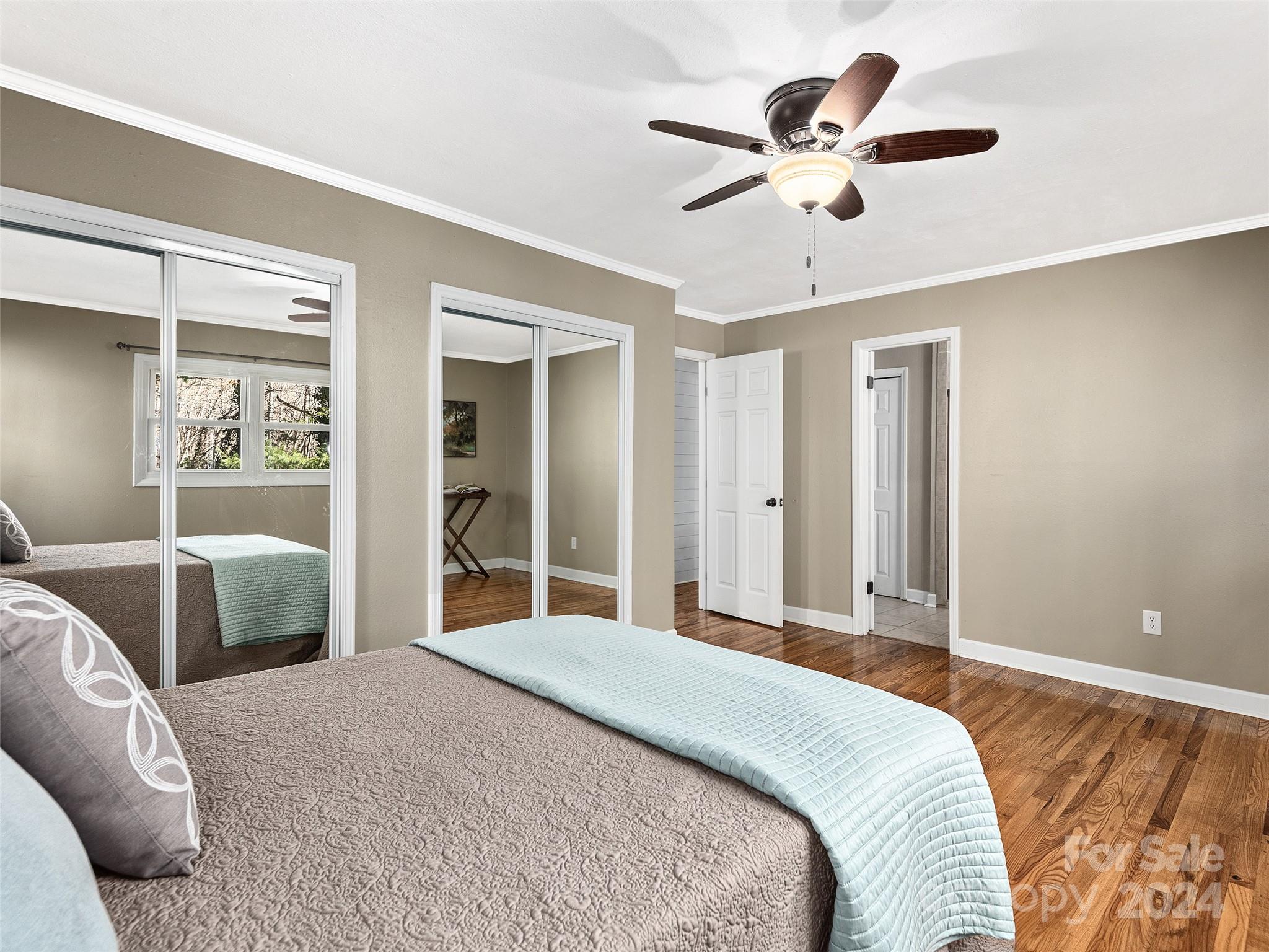 251 Jade Drive Clyde, NC 28721 - Photo 12 of 40 a bedroom with a large bed and a large window