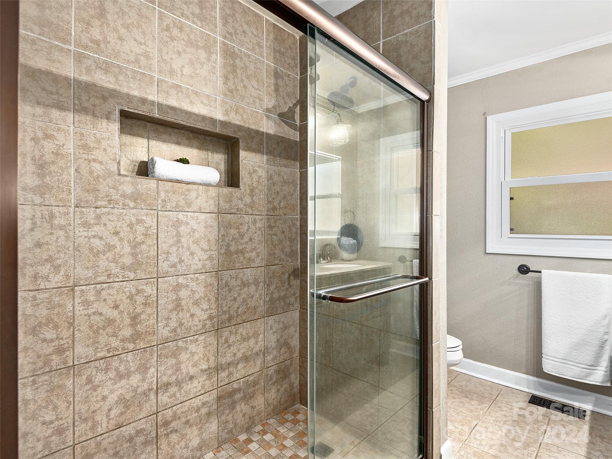 251 Jade Drive Clyde, NC 28721 - Photo 14 of 40 a bathroom with a glass shower door