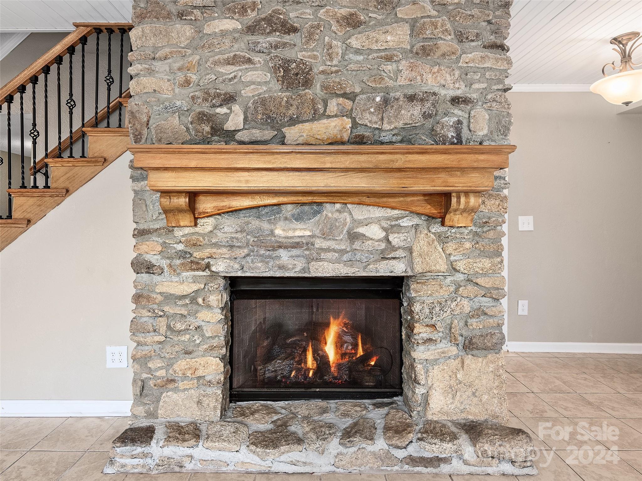 251 Jade Drive Clyde, NC 28721 - Photo 19 of 40 a fireplace with a clock on wall