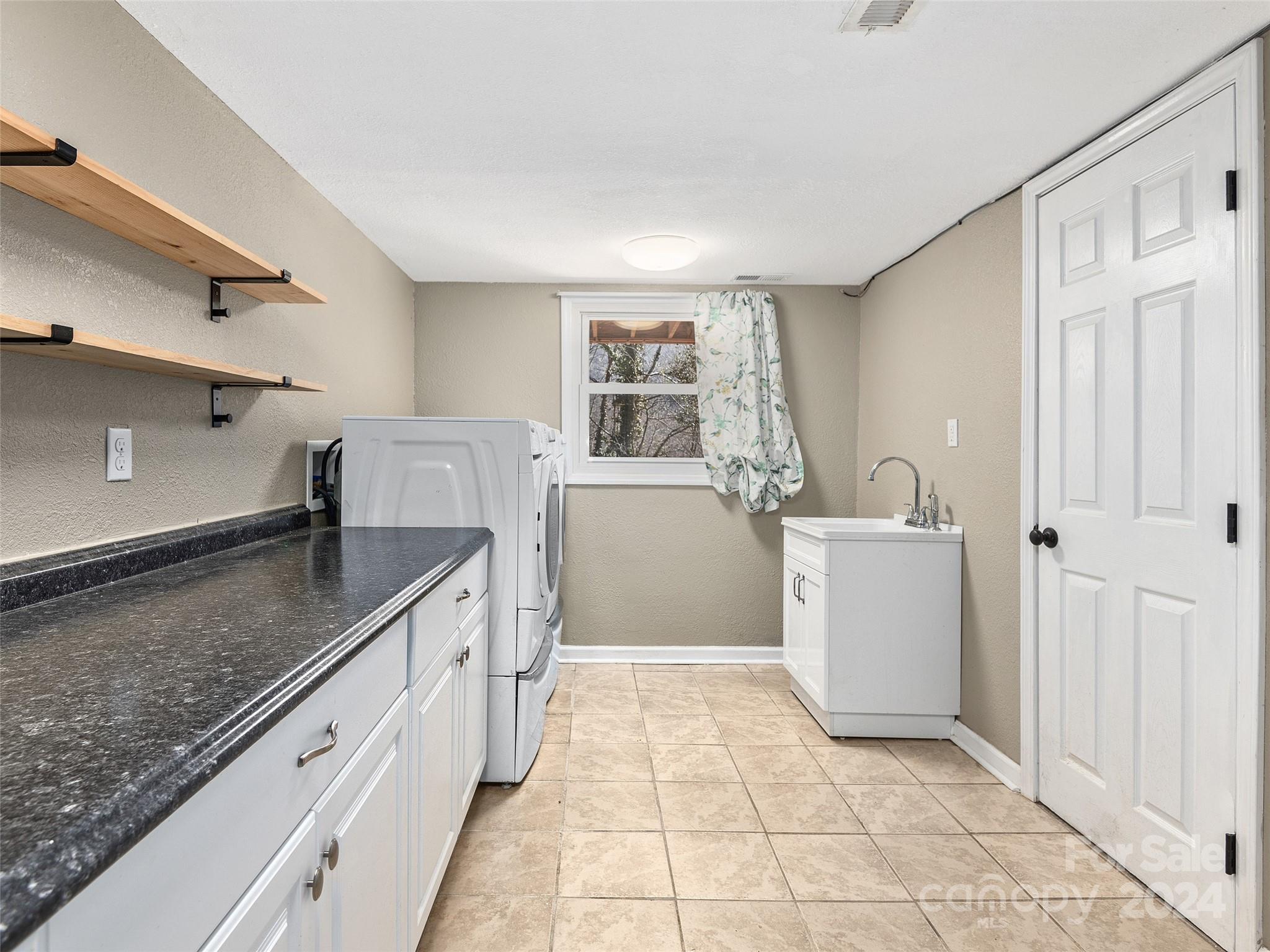 251 Jade Drive Clyde, NC 28721 - Photo 21 of 40 a kitchen with stainless steel appliances granite countertop a sink stove and cabinets