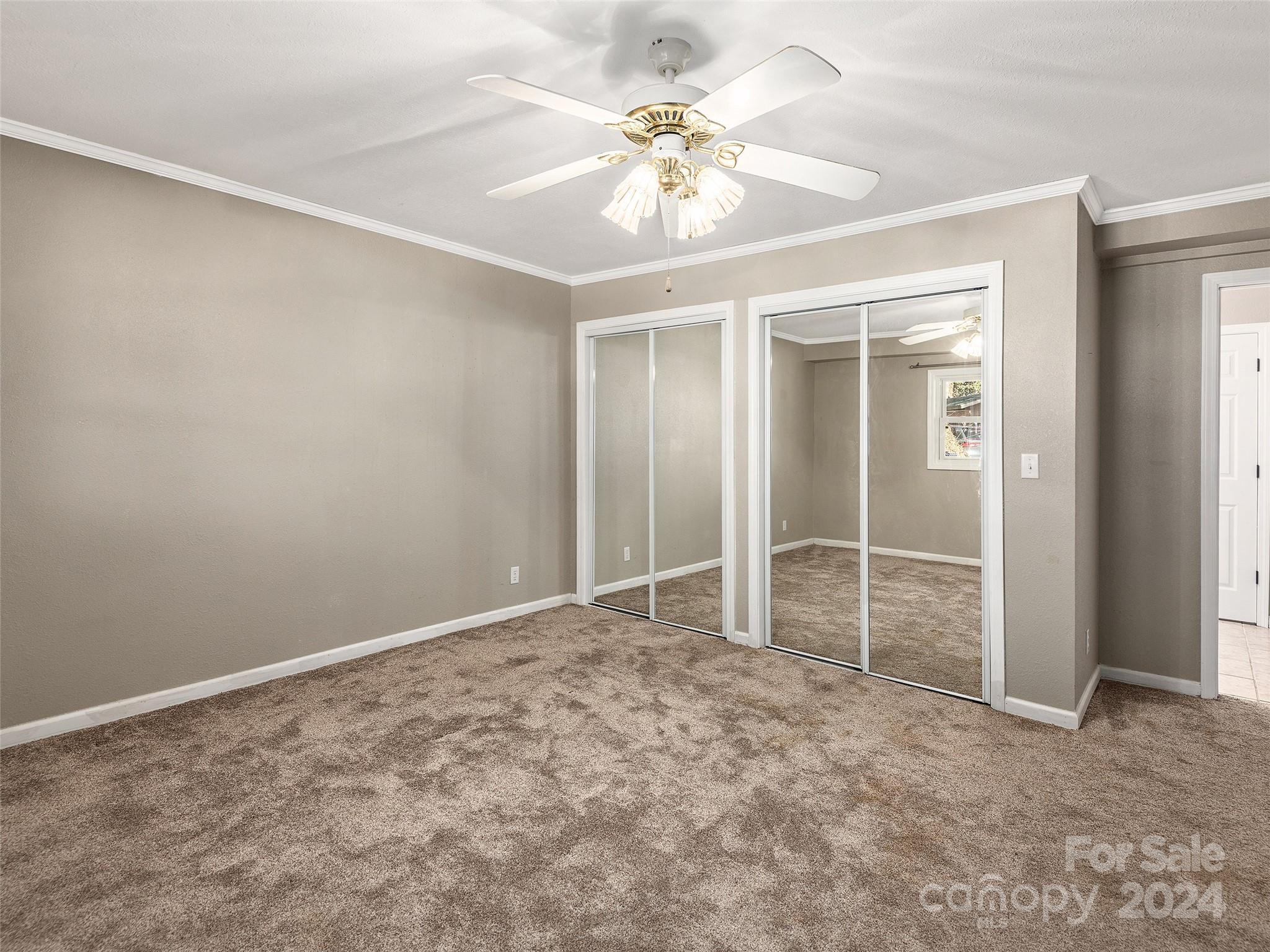 251 Jade Drive Clyde, NC 28721 - Photo 22 of 40 an empty room with closet and a ceiling fan