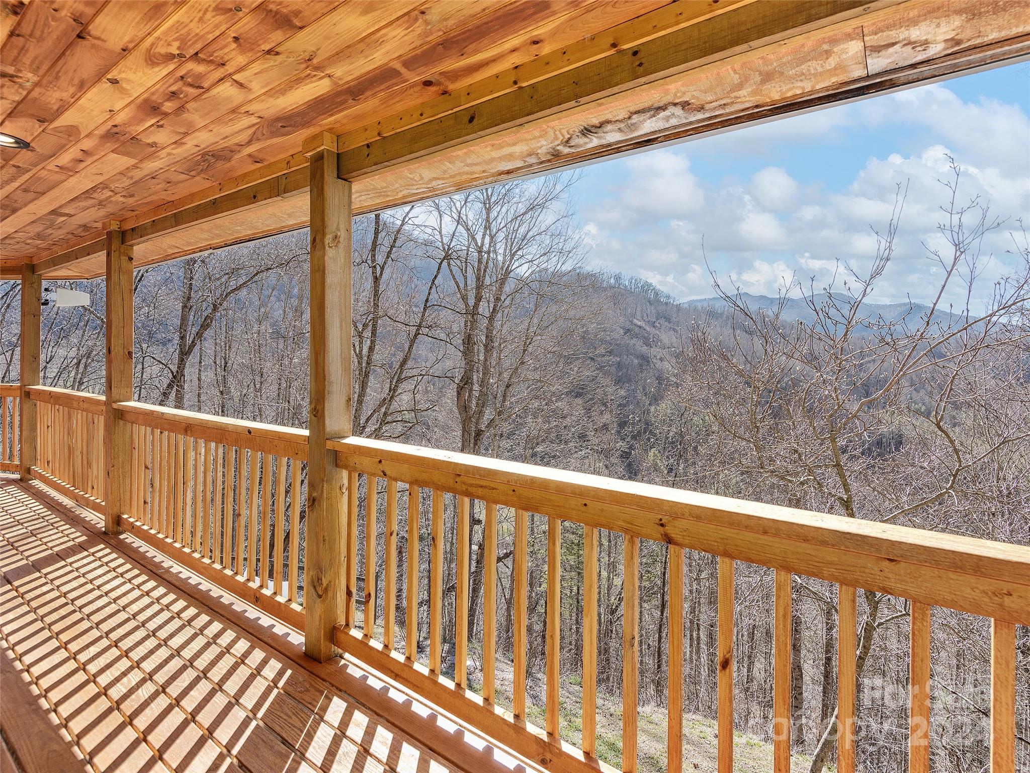 251 Jade Drive Clyde, NC 28721 - Photo 29 of 40 a view of a balcony with wooden floor and fence