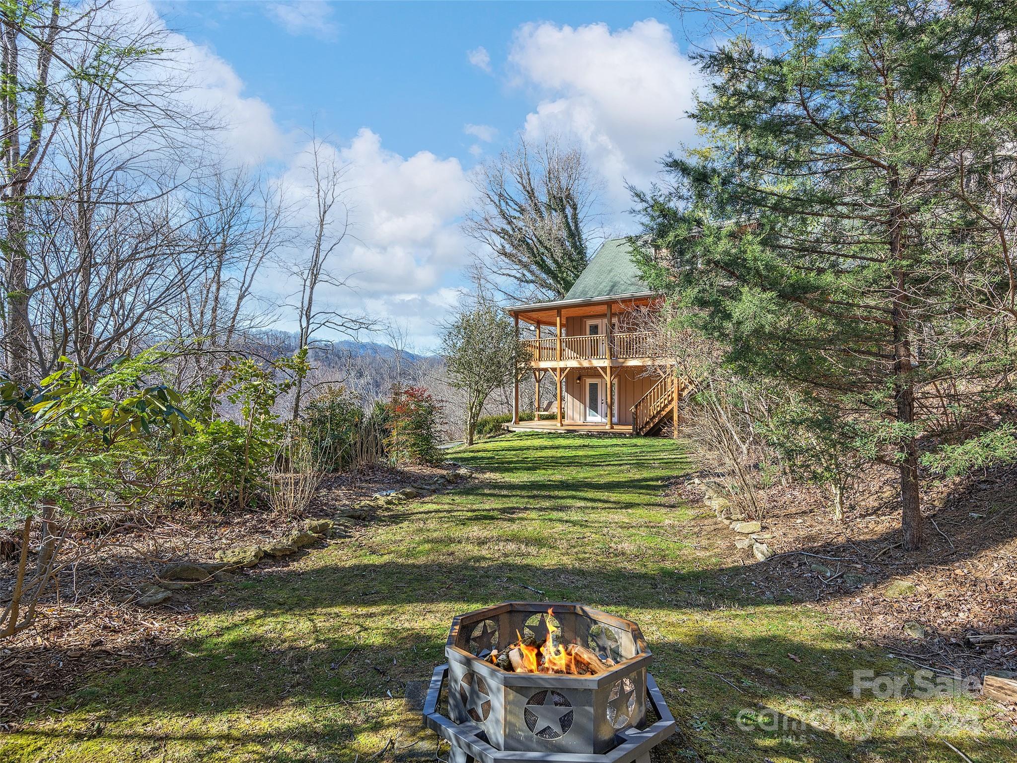 251 Jade Drive Clyde, NC 28721 - Photo 33 of 40 a view of a lake with a big yard