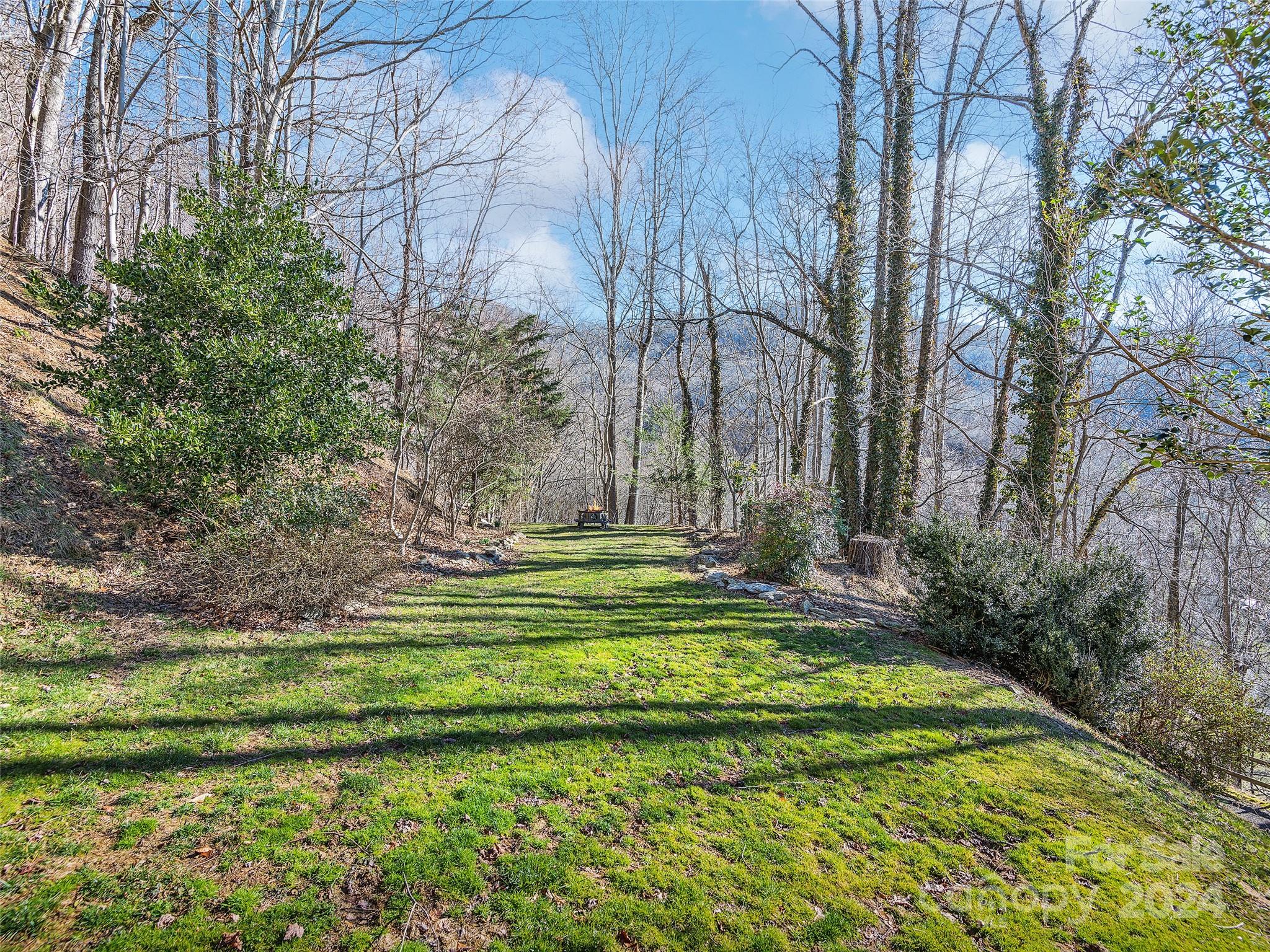 251 Jade Drive Clyde, NC 28721 - Photo 34 of 40 a swimming pool with outdoor seating and yard