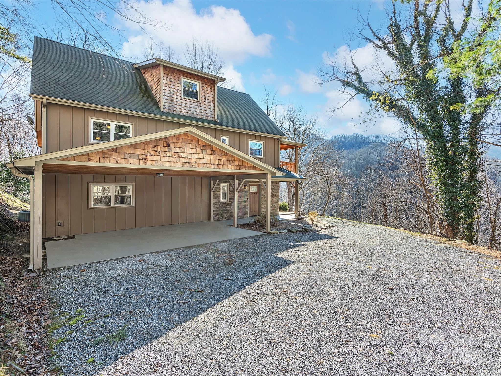 251 Jade Drive Clyde, NC 28721 - Photo 36 of 40 a front view of a house with a yard and garage