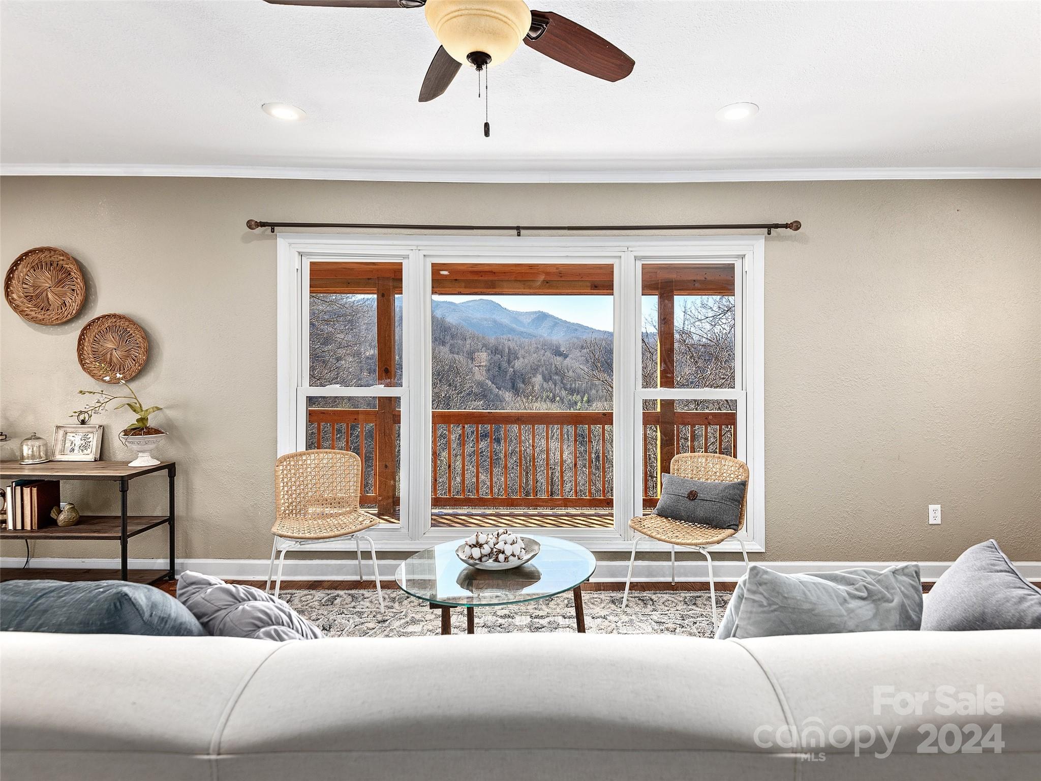 251 Jade Drive Clyde, NC 28721 - Photo 5 of 40 a living room with a large window and chandelier