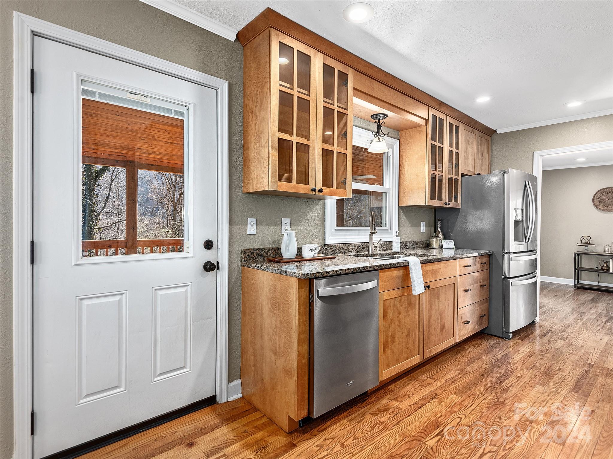 251 Jade Drive Clyde, NC 28721 - Photo 8 of 40 a kitchen with stainless steel appliances granite countertop a stove a sink and a refrigerator
