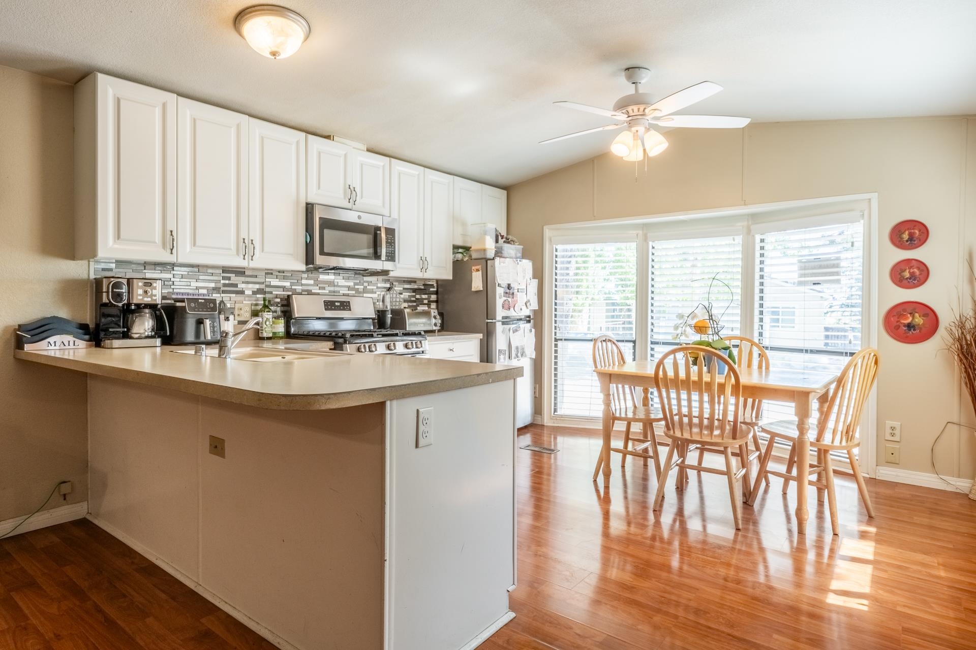 515 South Landing Road Crowley Lake, CA 93546 - Photo 12 of 41 a kitchen with stainless steel appliances granite countertop a stove top oven a sink a dining table and chairs with wooden floor