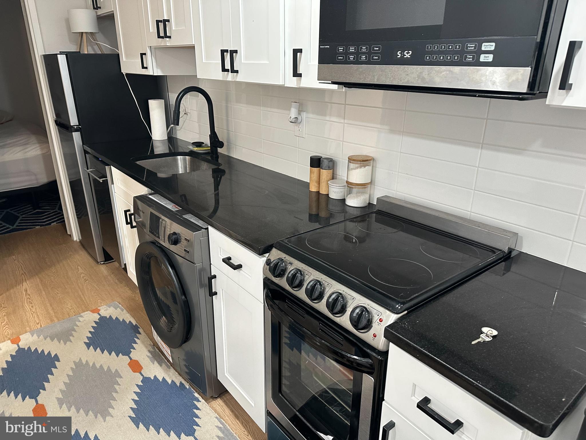 1018 Pine Street, Unit 2R Philadelphia, PA 19107 - Photo 3 of 4 a close view of a stove top oven and sitting space