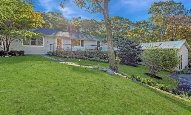 a front view of a house with a garden