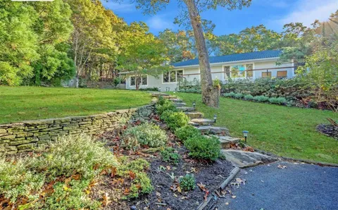 a view of a house with yard and a garden