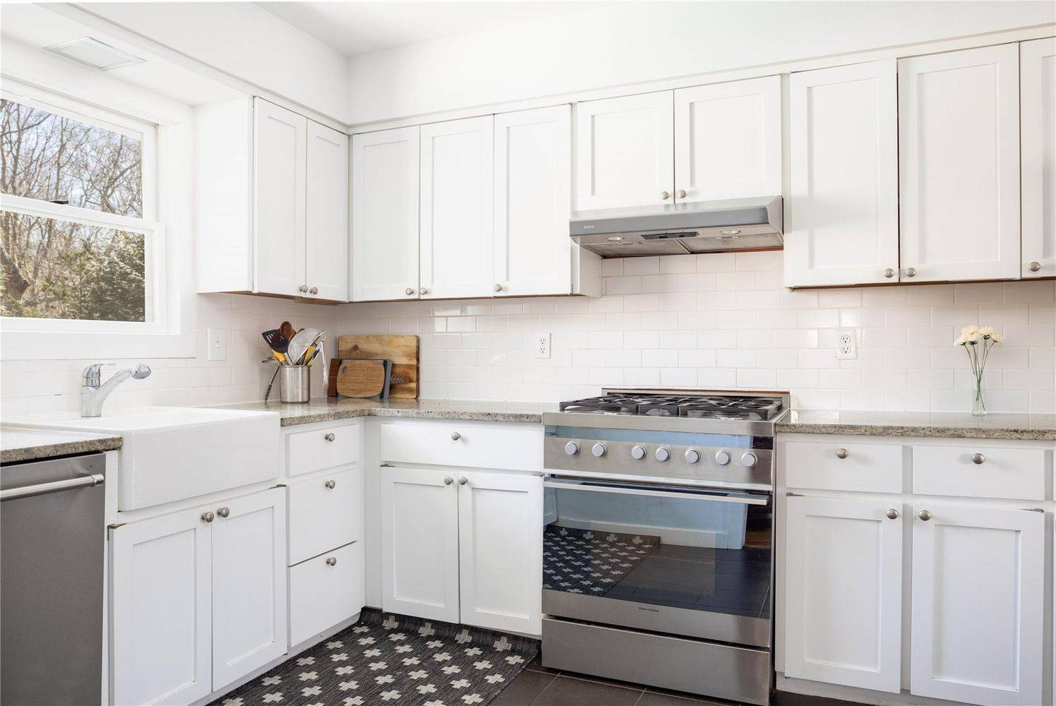 2 Captains Walk East Hampton, NY 11937 - Photo 8 of 22 a kitchen with white cabinets and appliances
