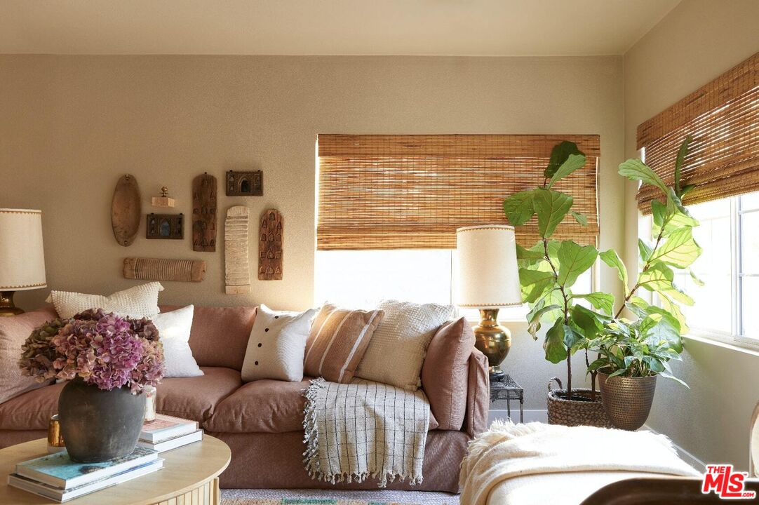 a living room with furniture and a potted plant