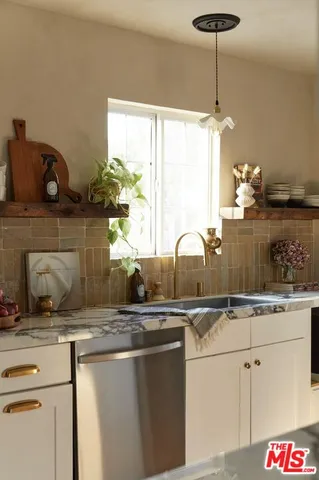 a kitchen with granite countertop a stove and a refrigerator