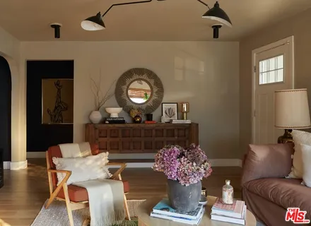 a living room with furniture and a large mirror
