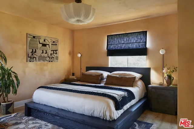 a vase of flowers sitting on a shelf