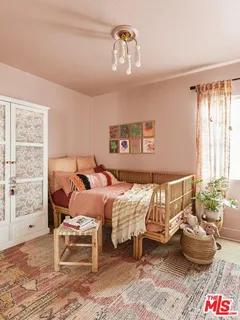 a bedroom with two beds and a large mirror