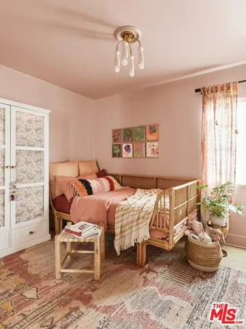 a bedroom with two beds and a large mirror