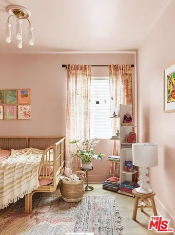 a bedroom with a bed a table and chair