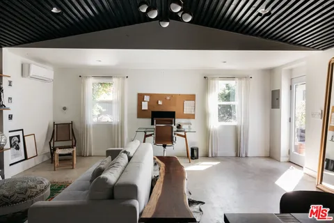 a living room with furniture and a potted plant