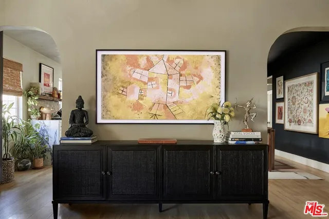 a living room with furniture and painting on the wall